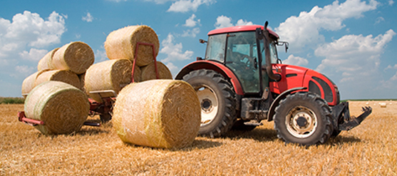 red tractor with bales